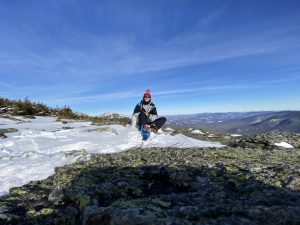 Al sits on a snowy mountain.
