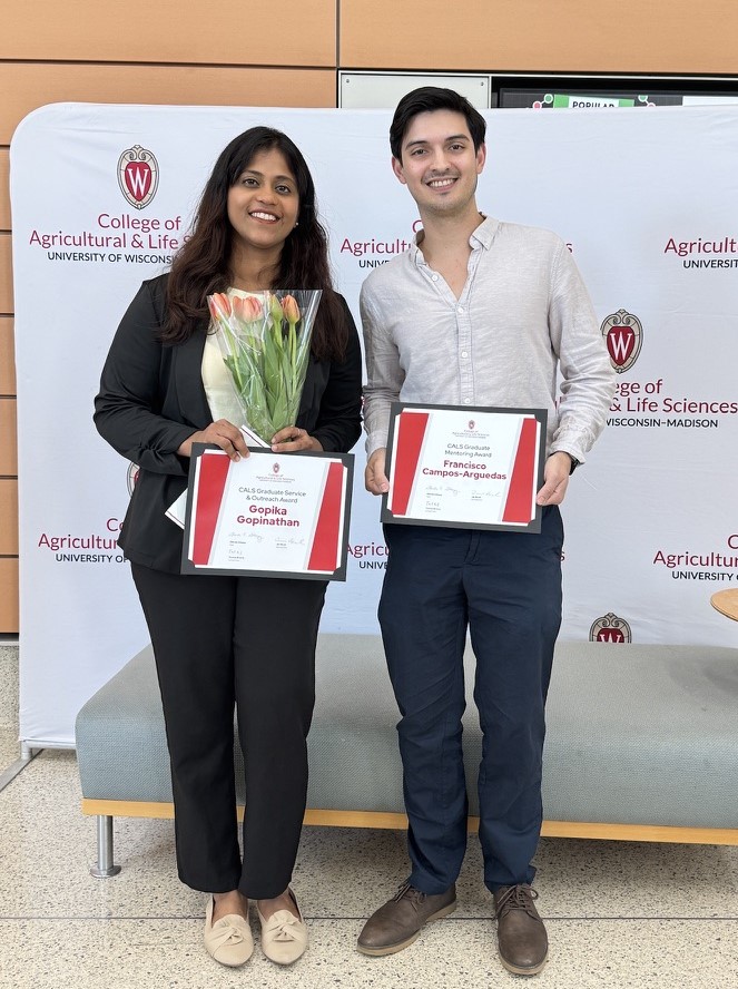 Gopika and Francisco smile and hold their awards at the CALS Awards Ceremony.